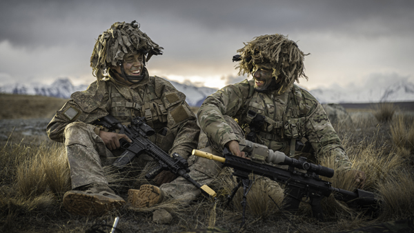 NZDF personnel in camouflage gear, laughing together